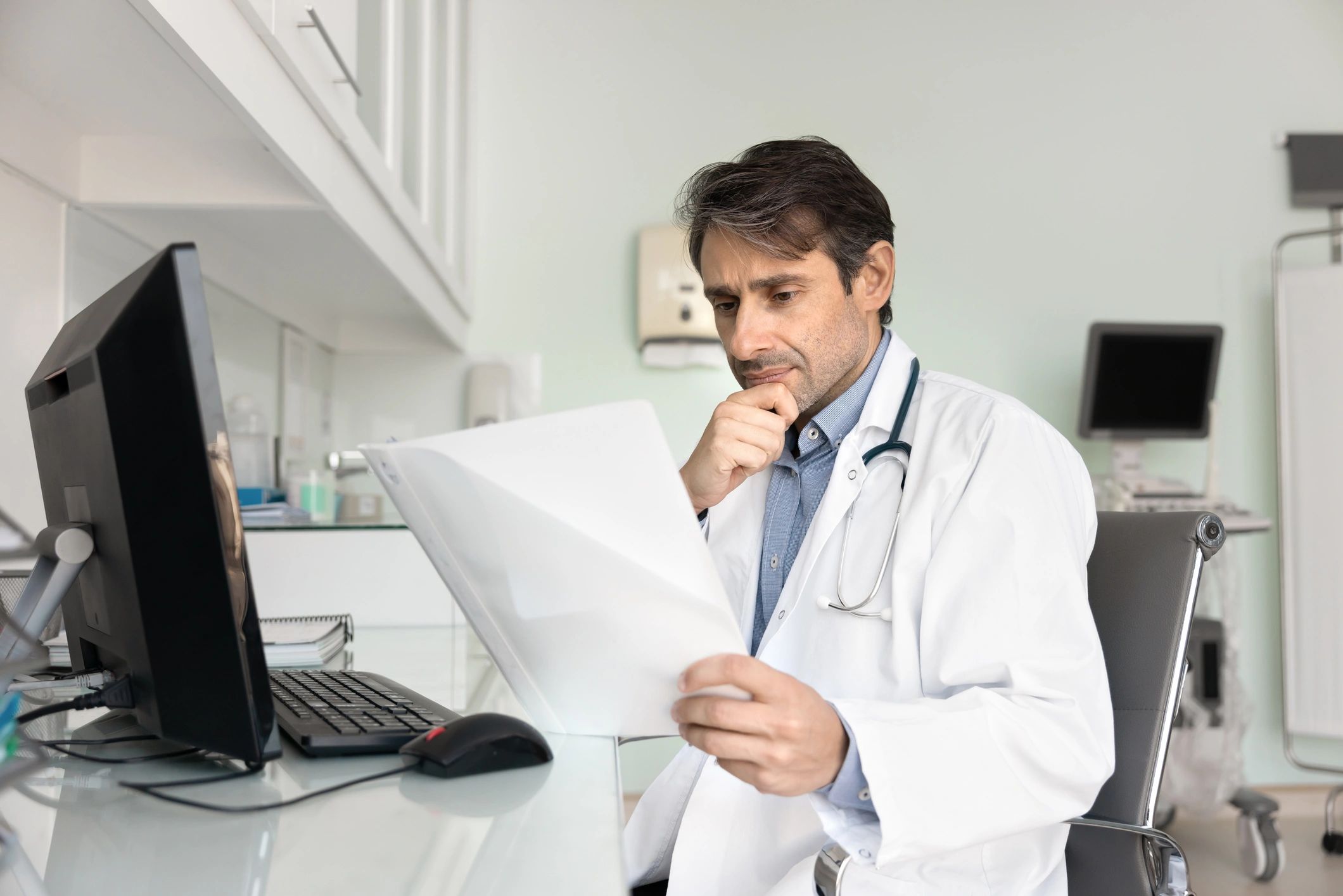 Doctor reviewing documents at a desk